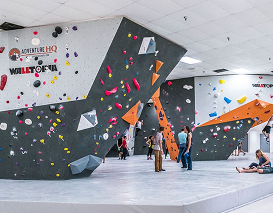 people standing around at a rock climbing gym
